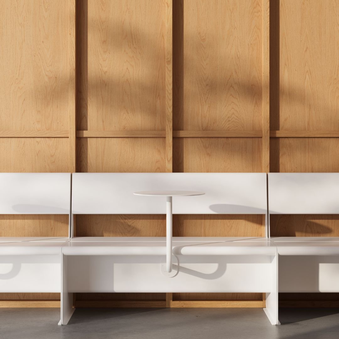 white booth seats sitting alongside each other with wall mounted cafe tables attached