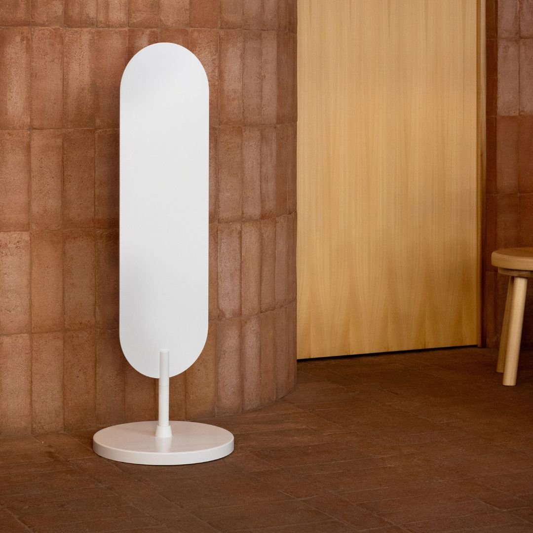 plain white large standing curve sign inside a wooden cafe interior