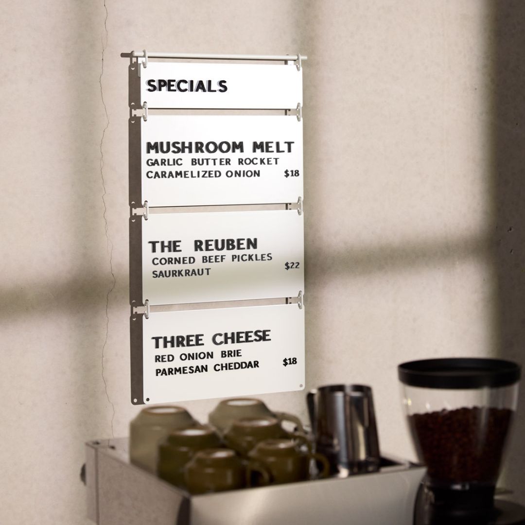 white hanging cafe menu displayed behind a countertop