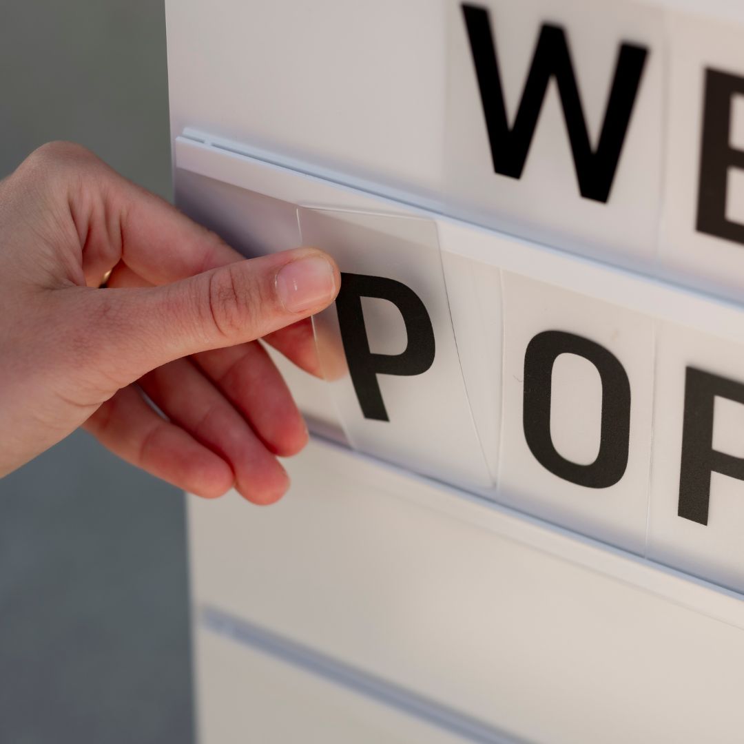 close up of the letters slotting in the grooves in the large letter a-frame sidewalk sign