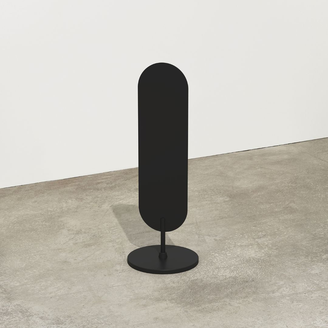 black plain large standing curve sign inside a studio