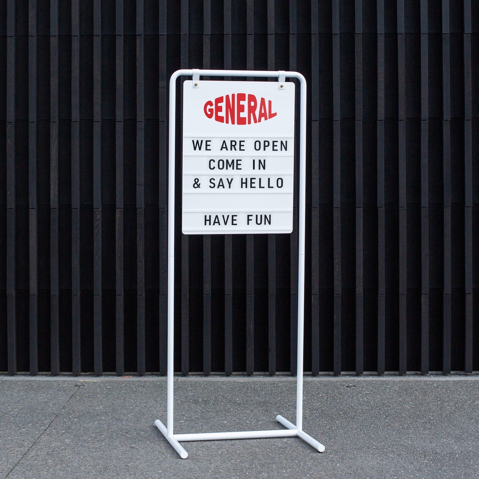 letter sidewalk sign outside on footpath in tall orientation with message showing on display
