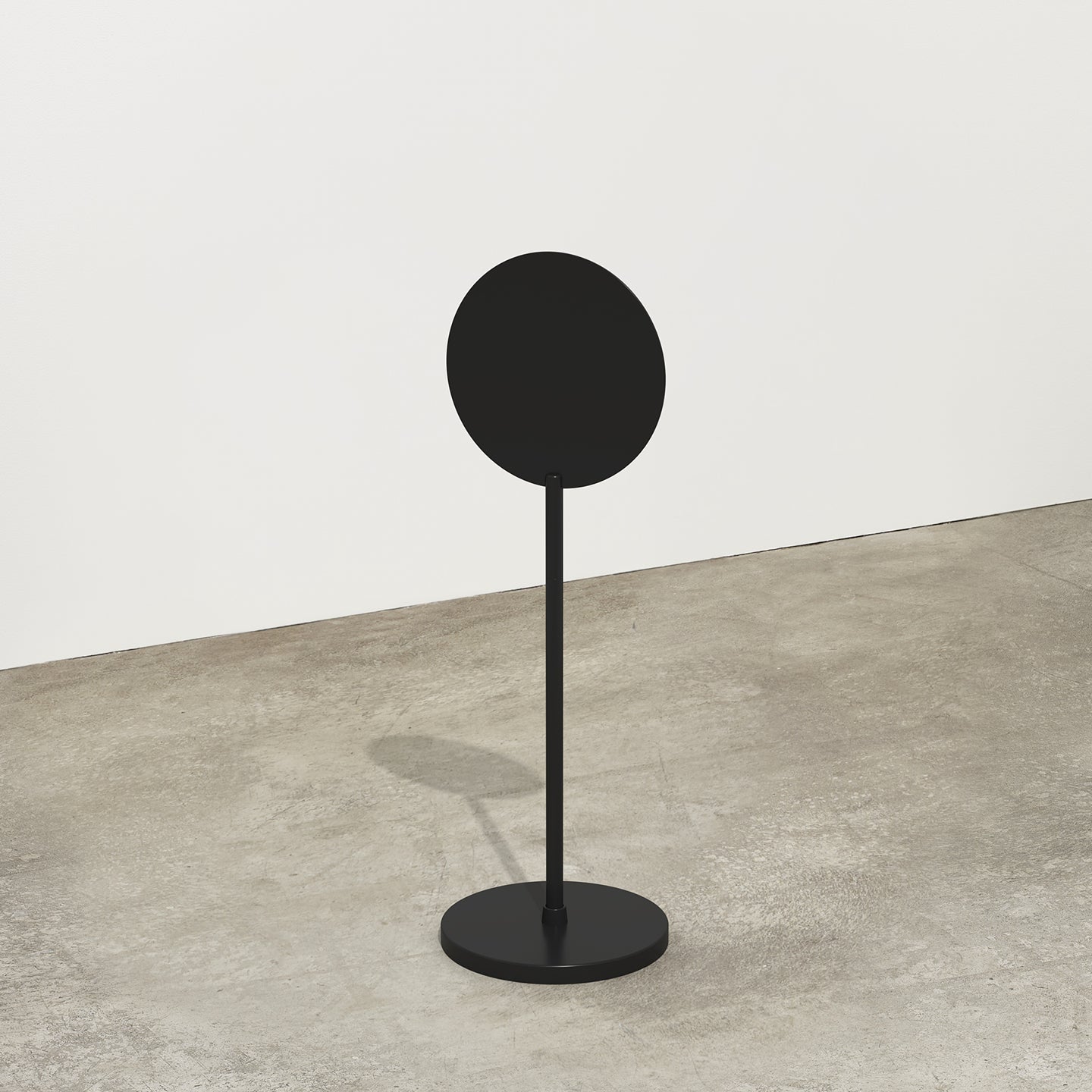 black metal standing round sign in a studio