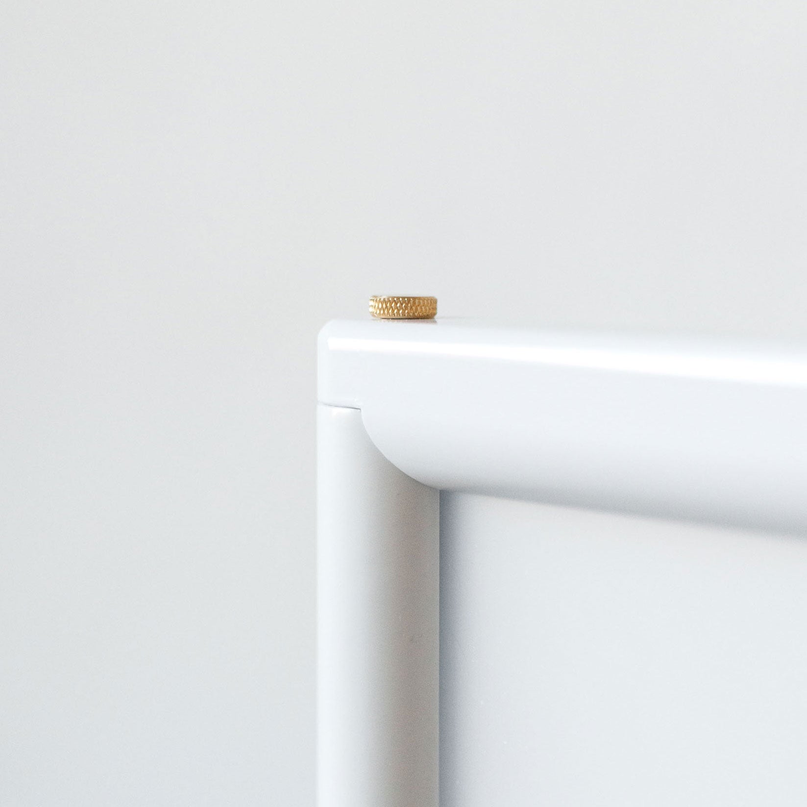 close up of the top corner of the poster sidewalk sign and the brass bolt used