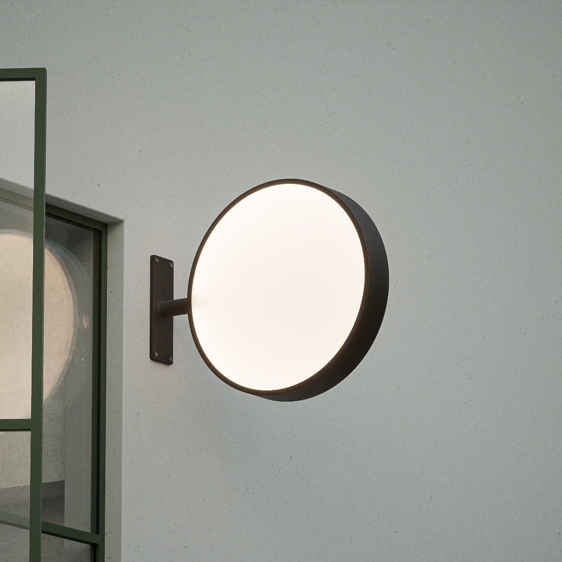 black round light box wall sign with light on