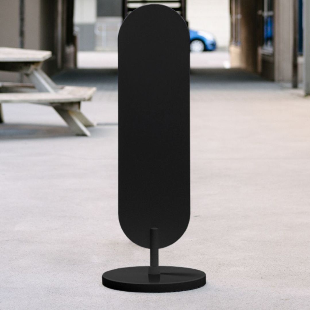 plain black large standing curve sign on sidewalk in an alleyway