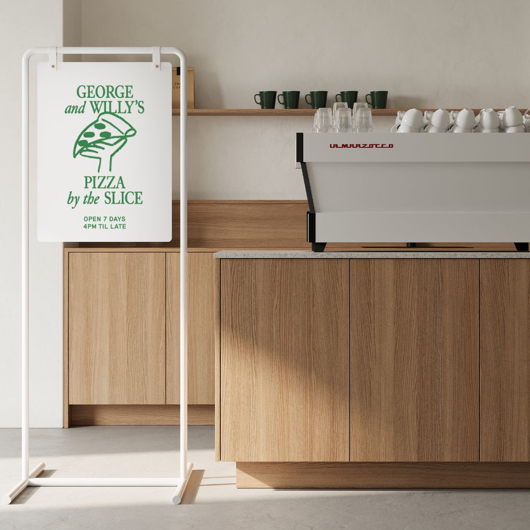 tall white swing business sign sign inside cafe interior in front of a counter