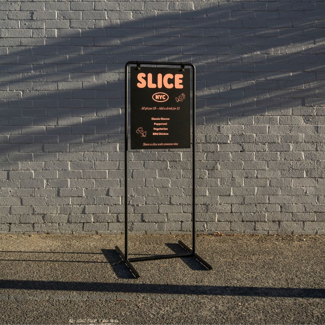 tall version of the swing business sign at golden hour on a sidewalk
