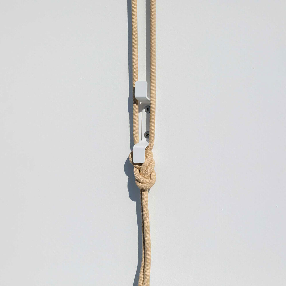 close up of ceiling hanging drying rack rope and cleat installed on wall