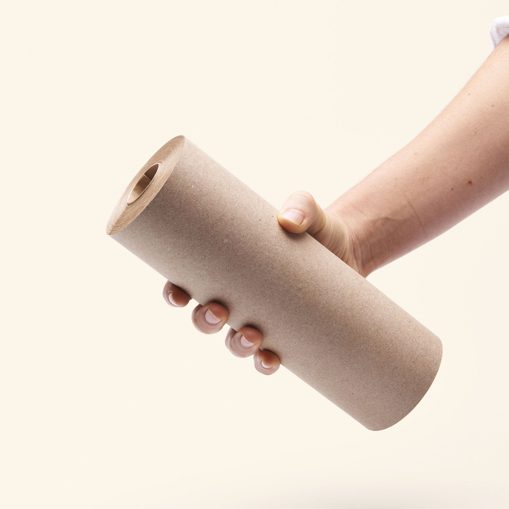 hand holding a daily roller brown kraft paper roll