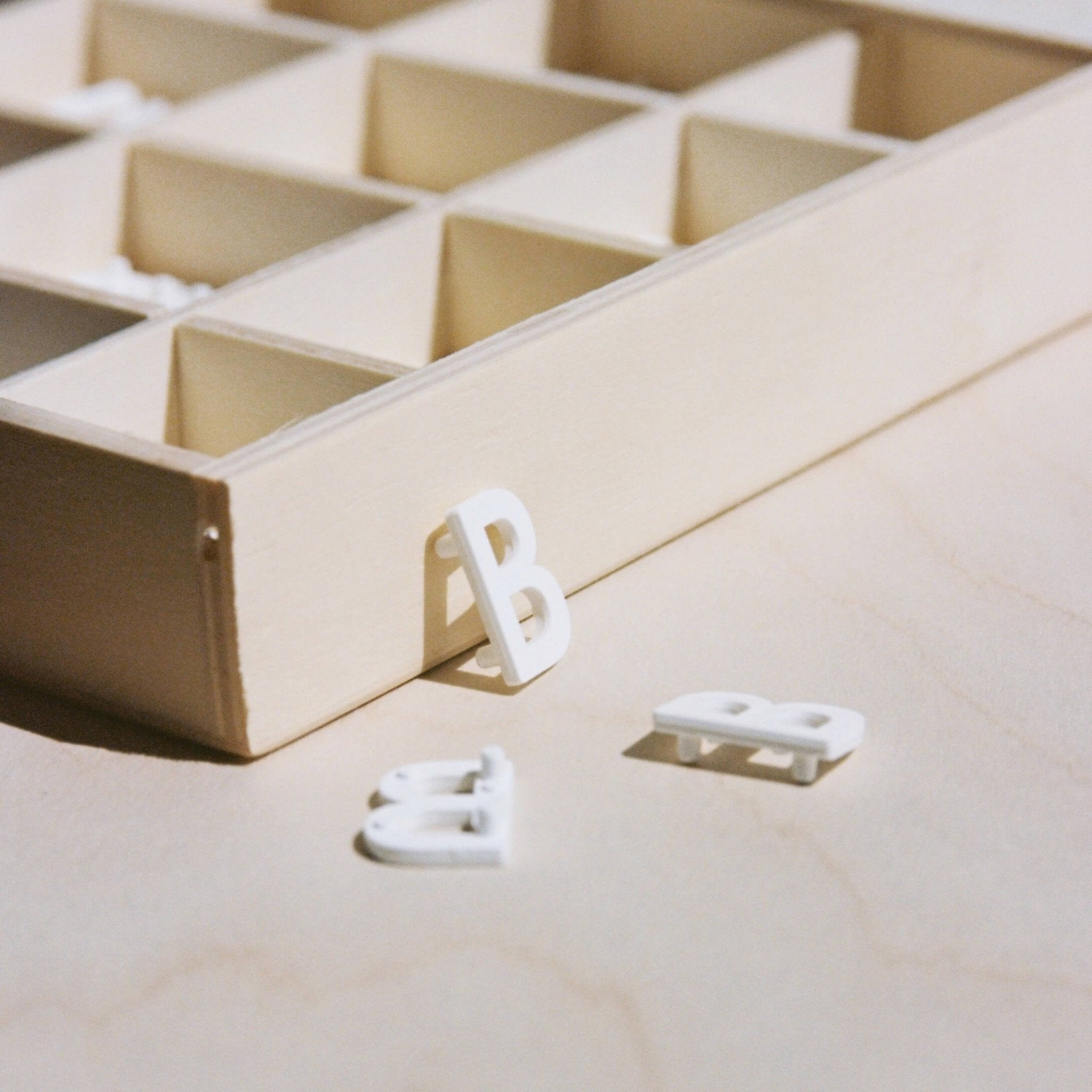 felt board menu letters lying on a counter beside their storage box