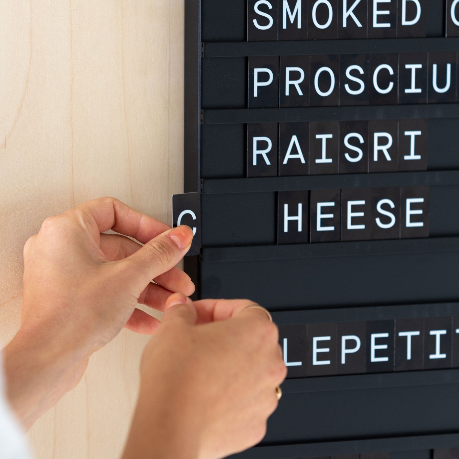 hand showing how the menu board letters are assembled in the menu board