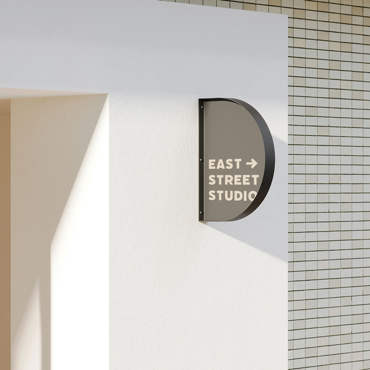 wall-mounted storefront sign installed on a wall outside a shop