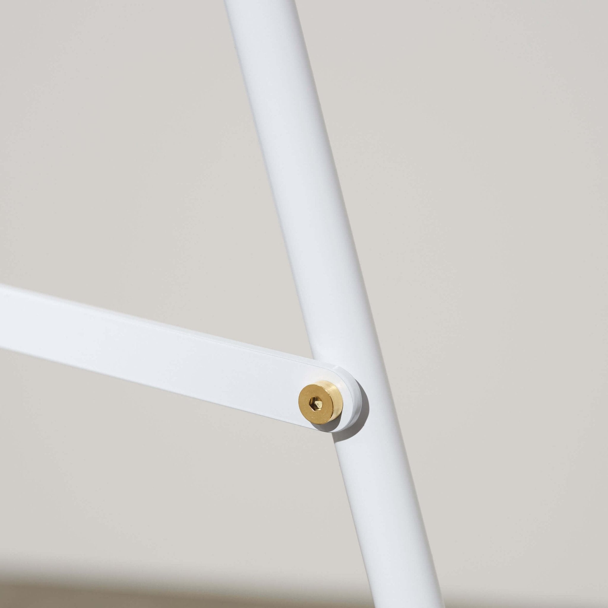 close up of the white sidewalk pavement sign showing bolts and joinery