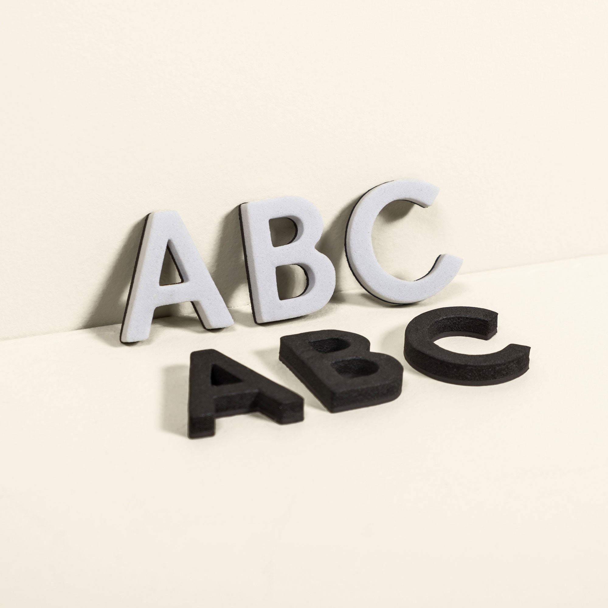 white and black magnet letters showing A B C