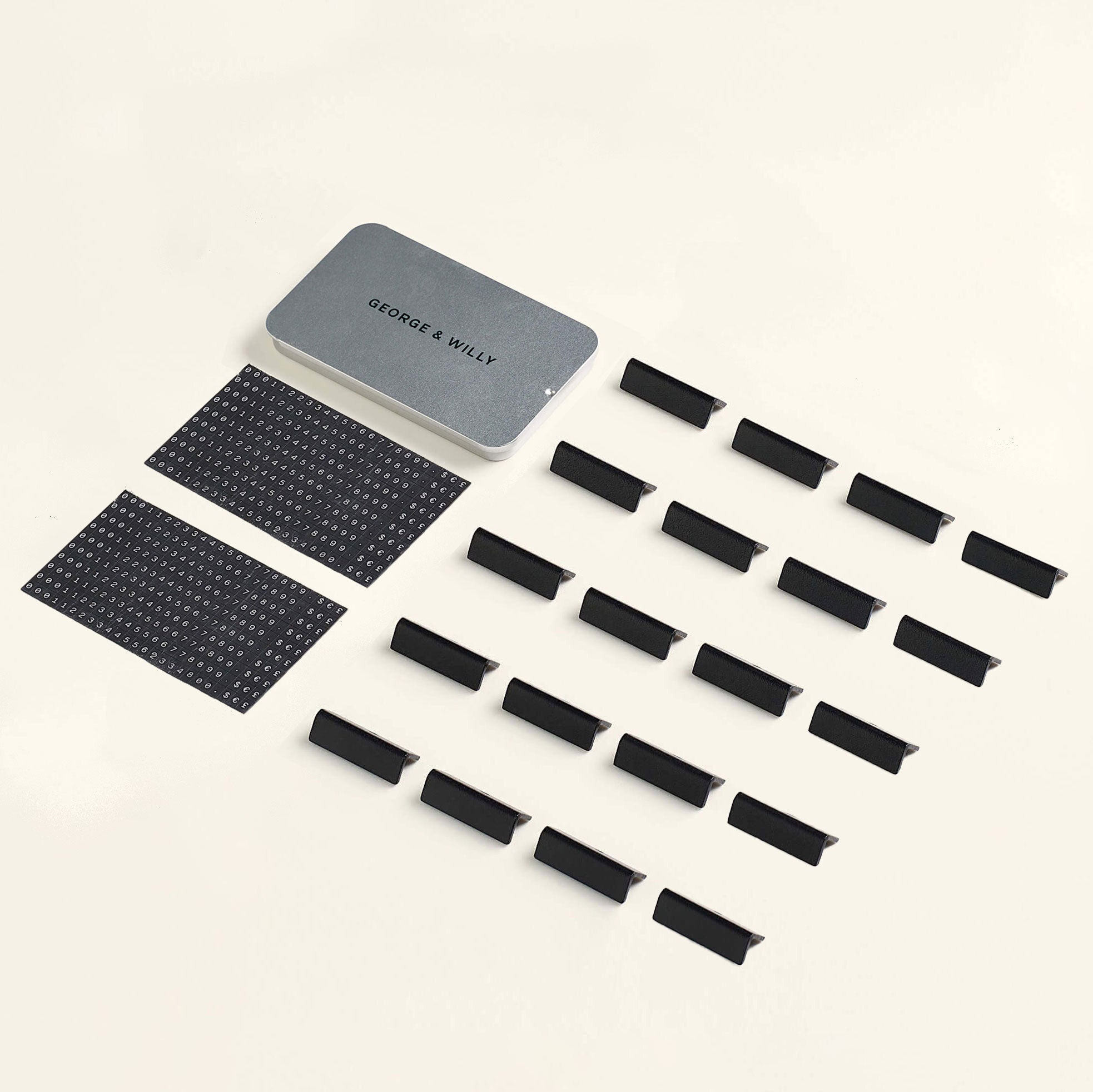 the contents of the pricing sign box laid out neatly showing metal container, magnet letters and pricing tags