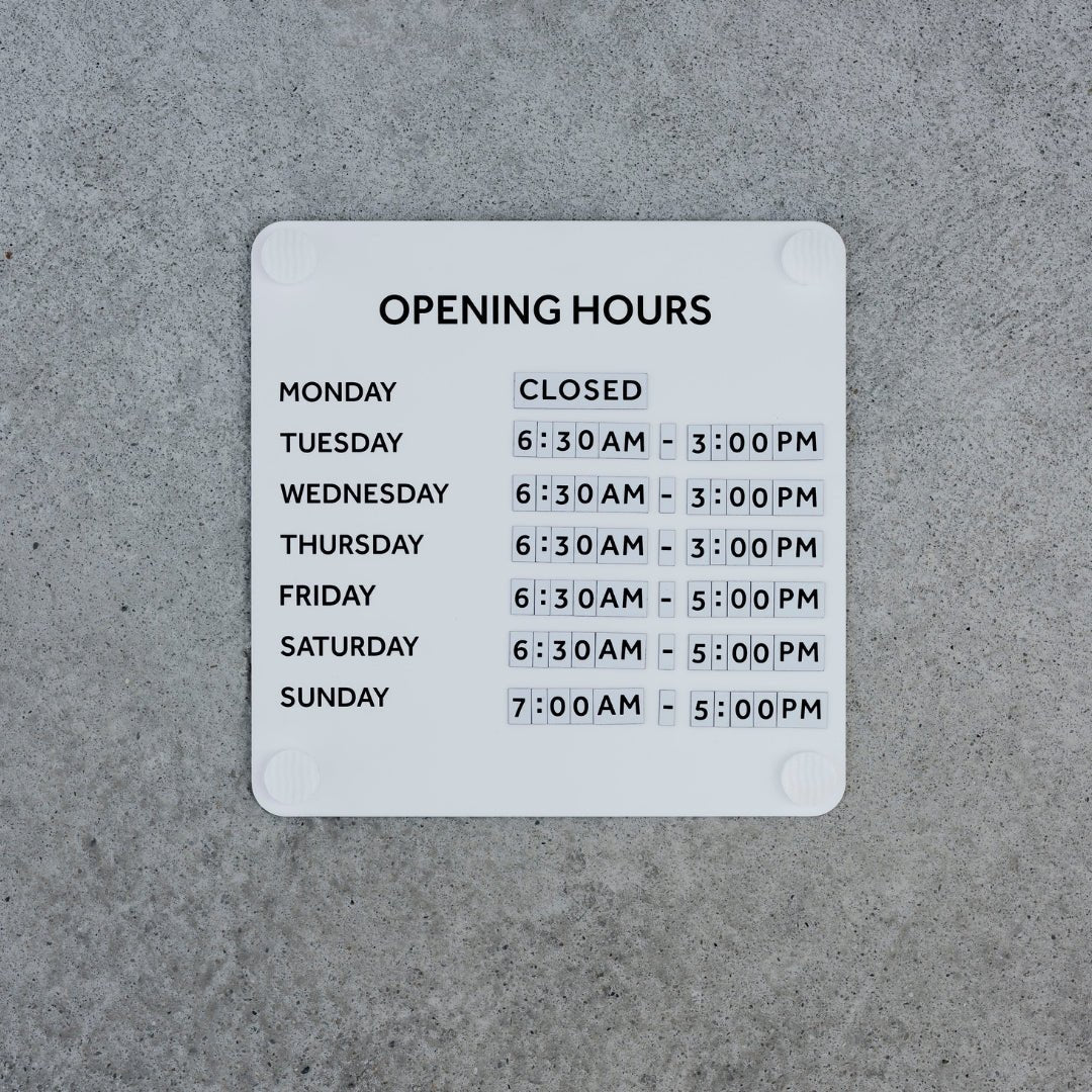 business hours advertising sign for window in white steel finish with magnetic numbers arranged neatly