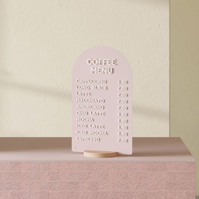 pink arch tabletop sign on a pink countertop
