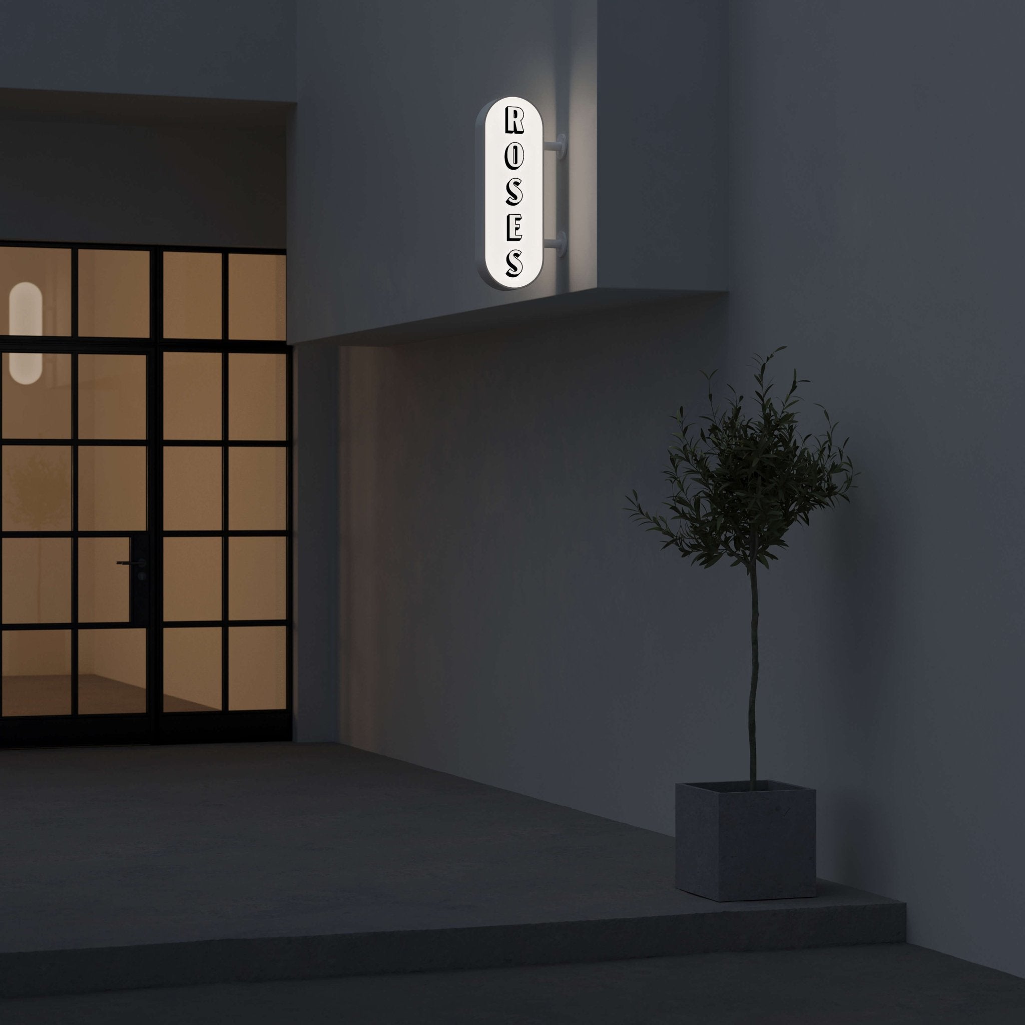 nighttime shot of the black curve lightbox sign with logo branding applied installed on a storefront and wall-mounted
