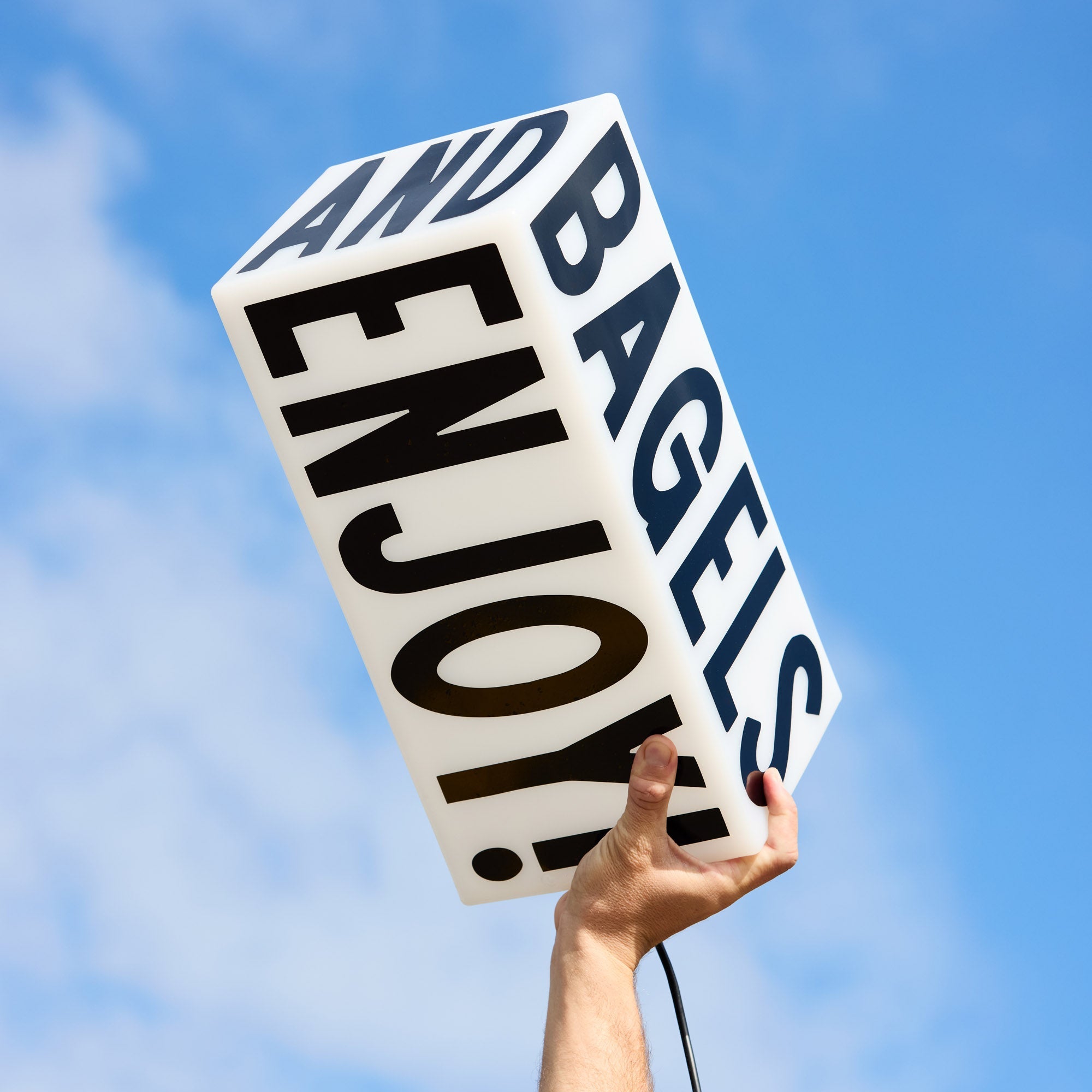 LED sign photographed outdoors against a clear blue sky, showing modern rectangular design