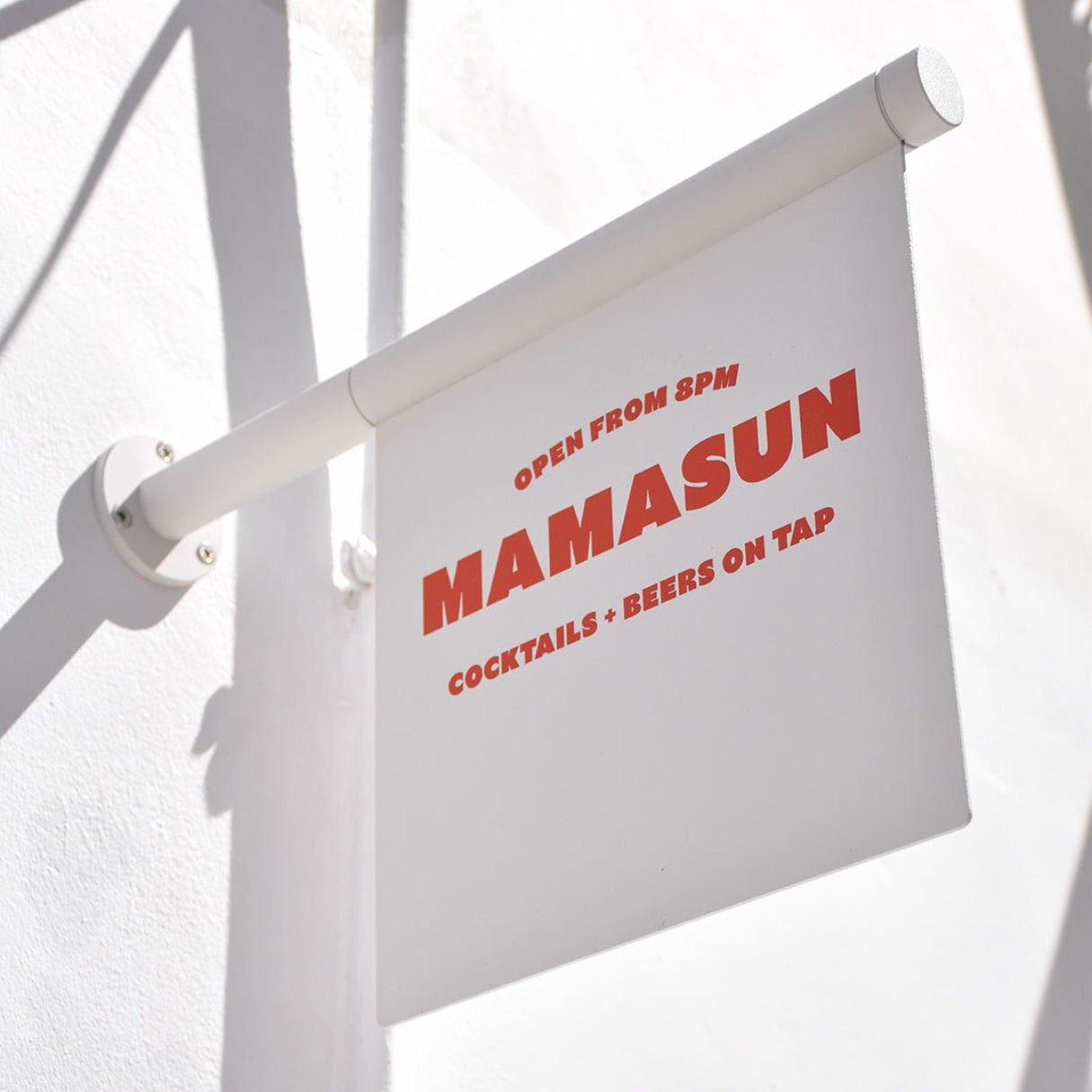 white wall-mounted flag business sign with "mamasun" logo branding on it