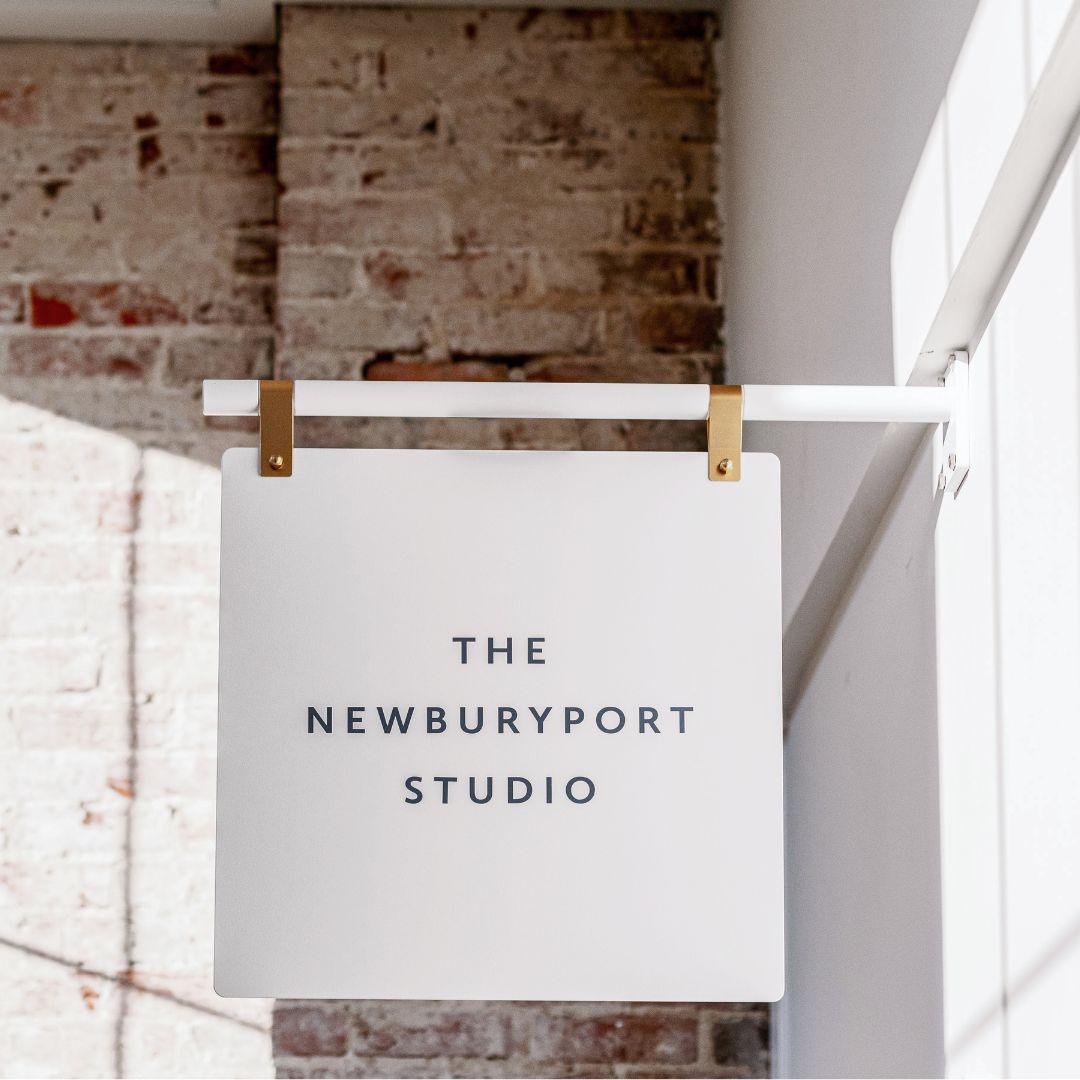 white metal luxury hanging store sign with brass straps