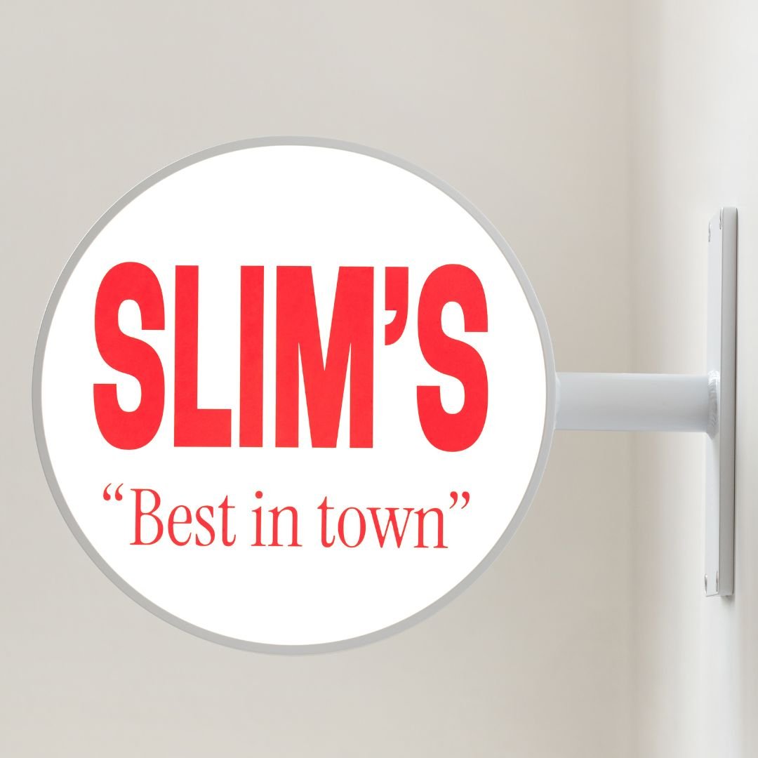 white round light box sign installed inside with "slim's" red logo branding on the panel