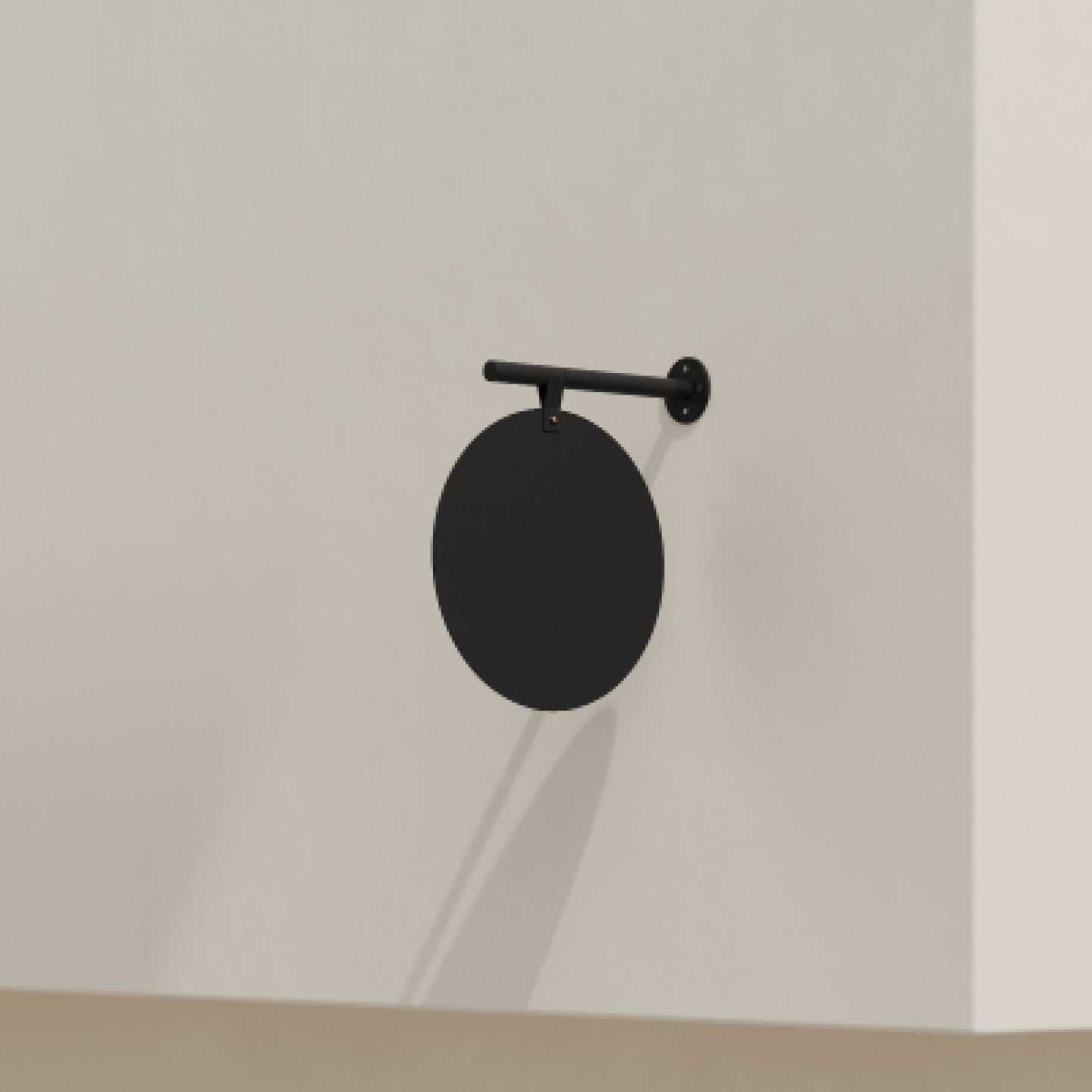 plain black hanging round store sign on a white brick facade