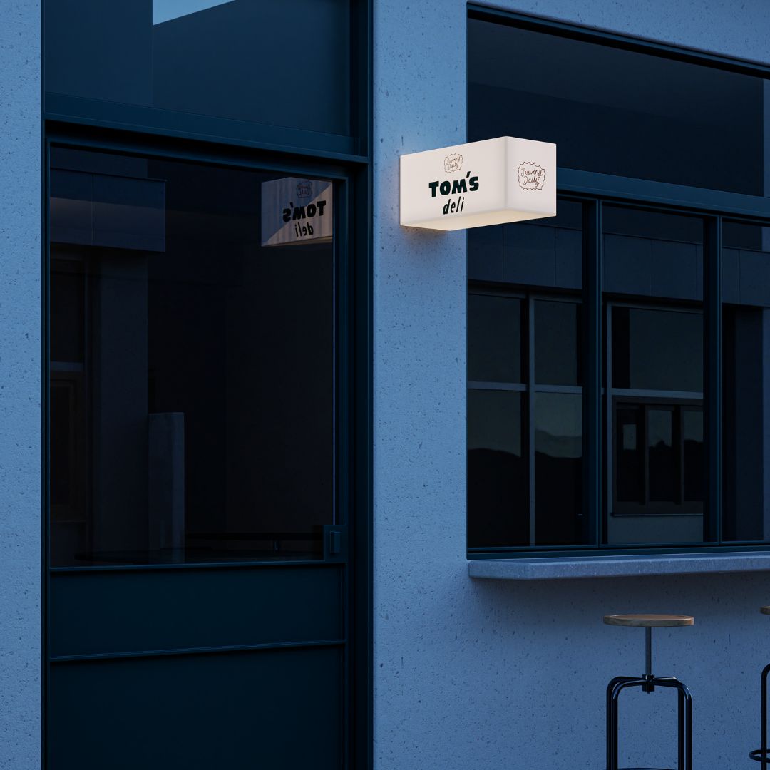 Outdoor plastic light up sign turned on at night, highlighting 3D rectangular form