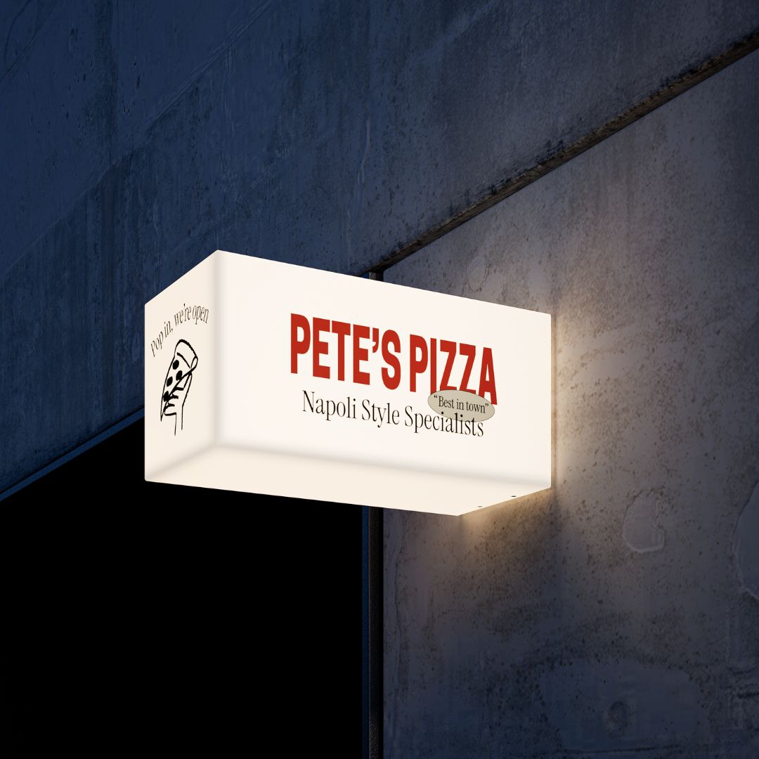Plastic rectangular light box sign illuminated in warm white, showing soft ambient glow