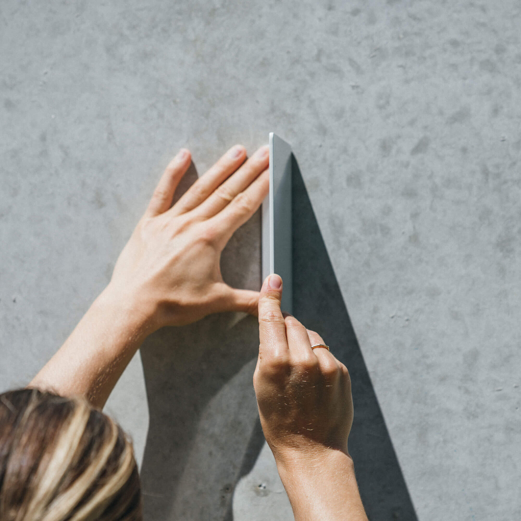 front on showing the fold of the square custom metal blade sign and how its attached to the wall