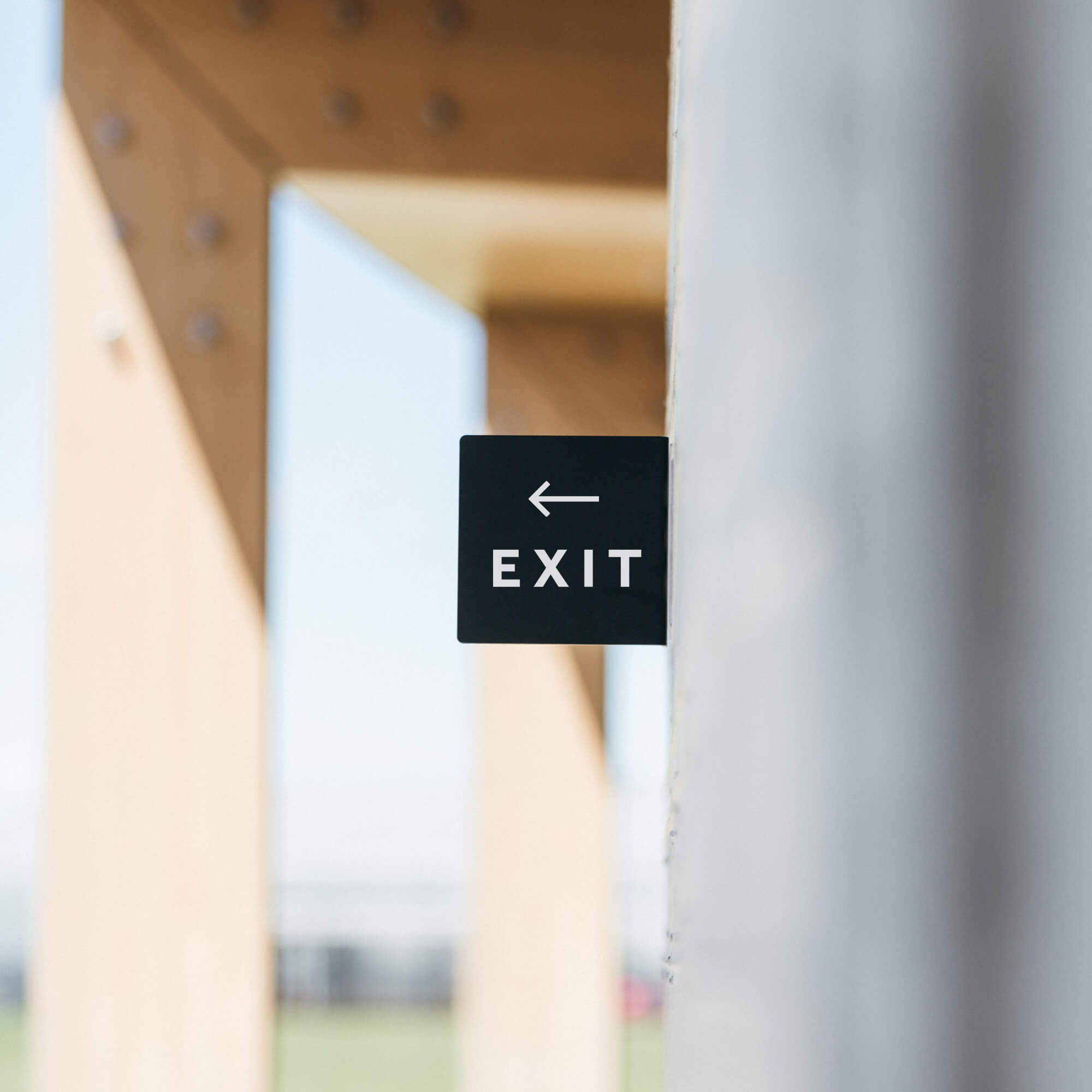 black square balde sign installed on a cement wall