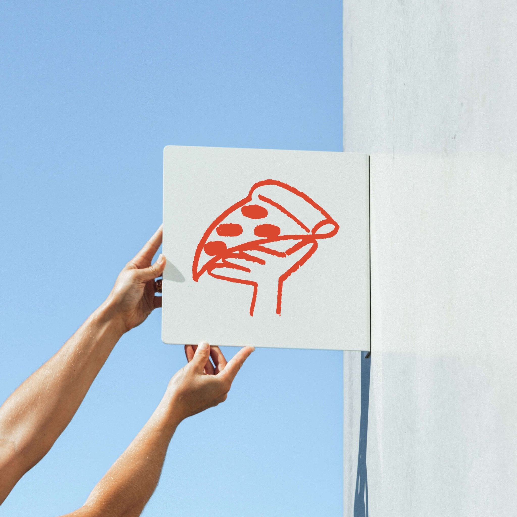 two hands holding up a square blade sign with a pizza logo branded on it