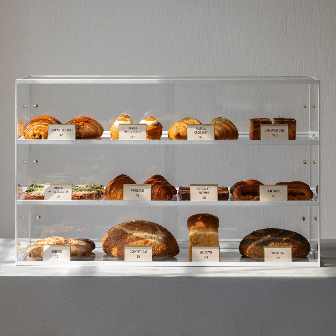 three-tier bakery and collectables display cabinet on top of counter