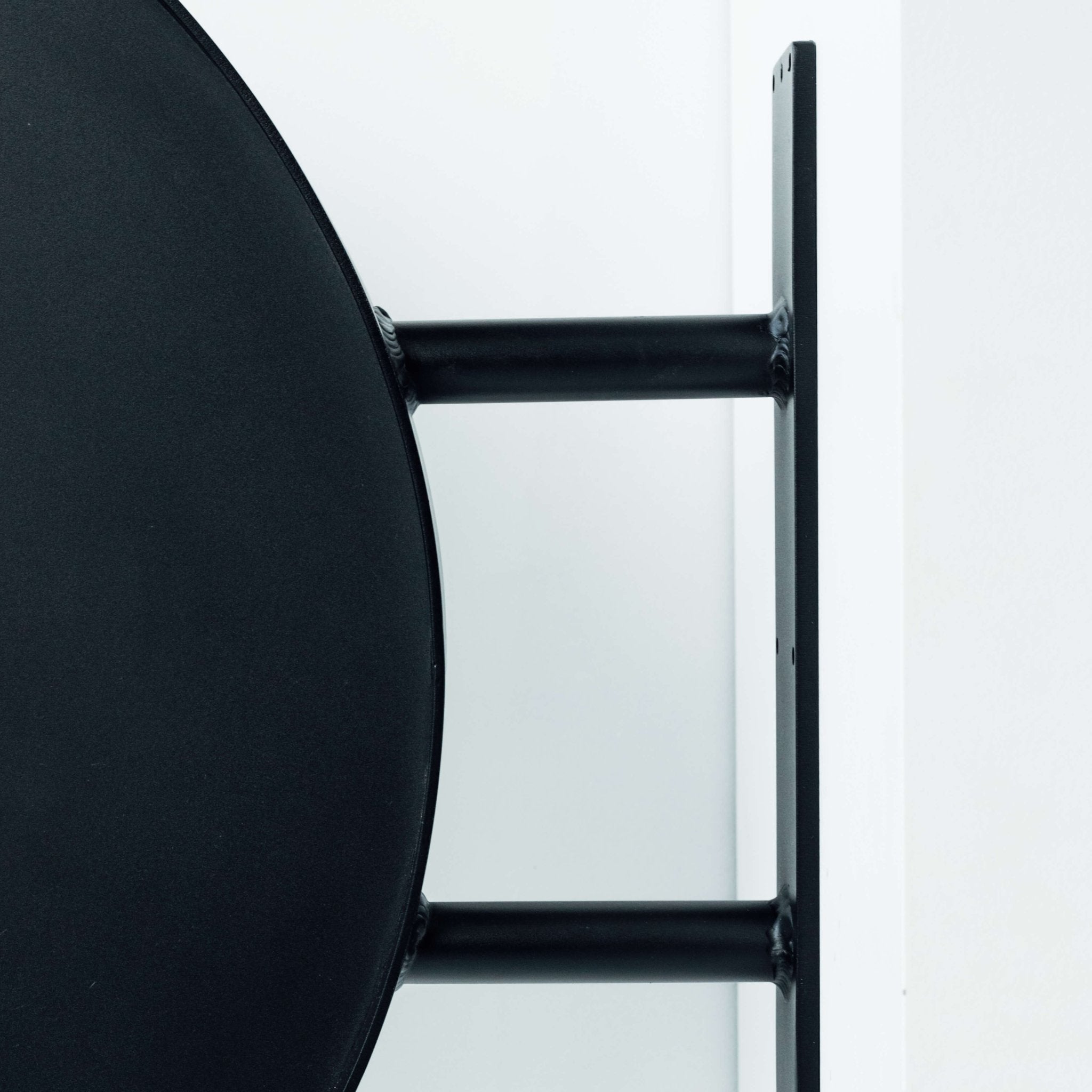 Side view of round wall sign showing sturdy aluminum mounting bracket