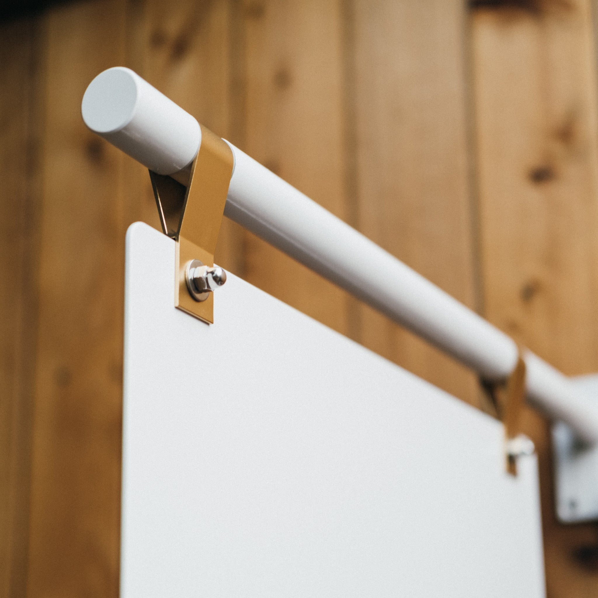 close up of brass straps used for the wall mounted store sign