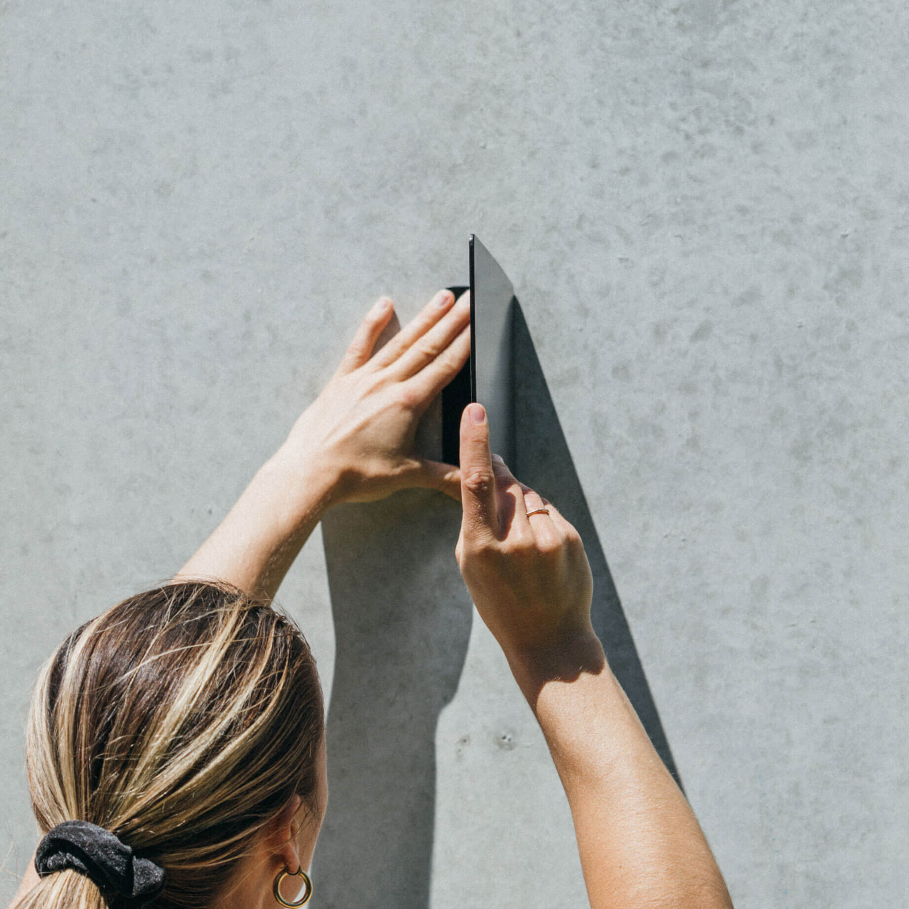 front on view of person installing the blade sign